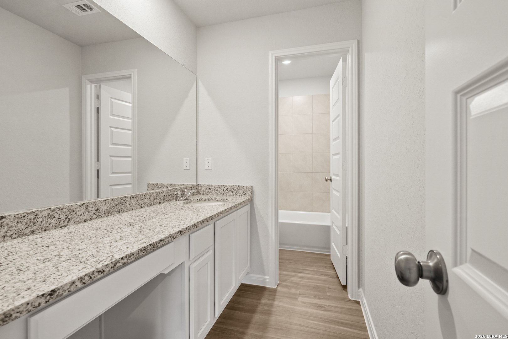 13631 Helton Pass St. Hedwig, TX 78152 - Photo 22 of 33 a bathroom with a granite countertop sink and a mirror