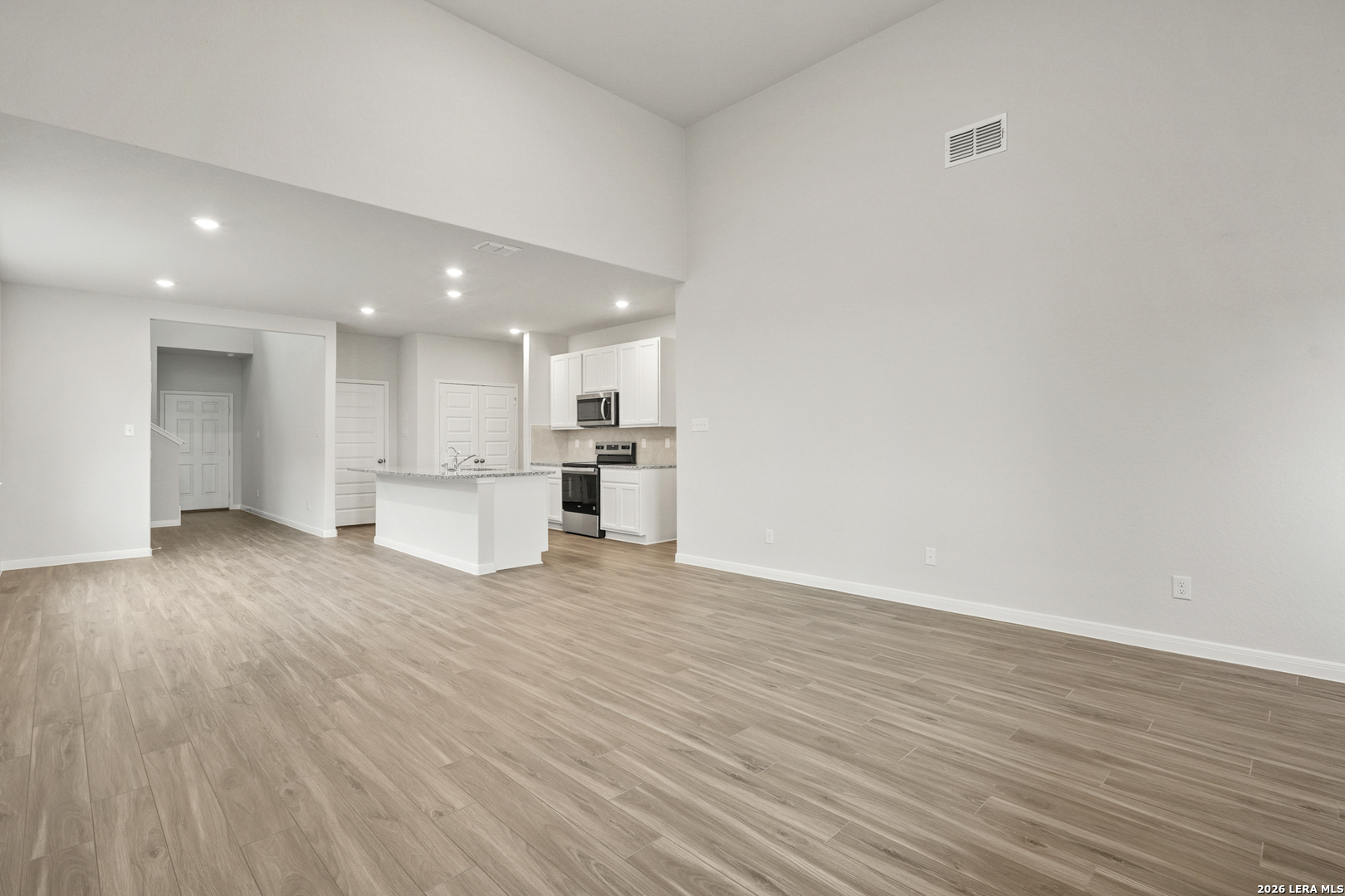 13631 Helton Pass St. Hedwig, TX 78152 - Photo 4 of 33 a view of kitchen with kitchen island wooden floor center island and stainless steel appliances