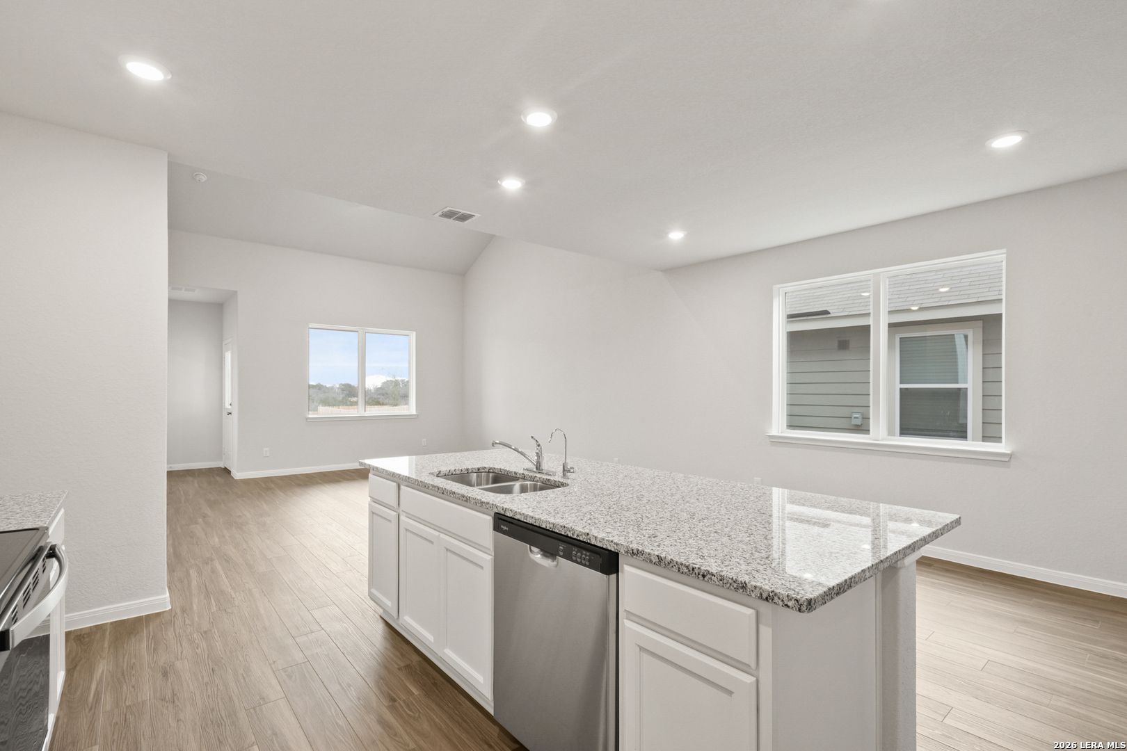13631 Helton Pass St. Hedwig, TX 78152 - Photo 5 of 33 a kitchen that has a sink a stove and wooden floor