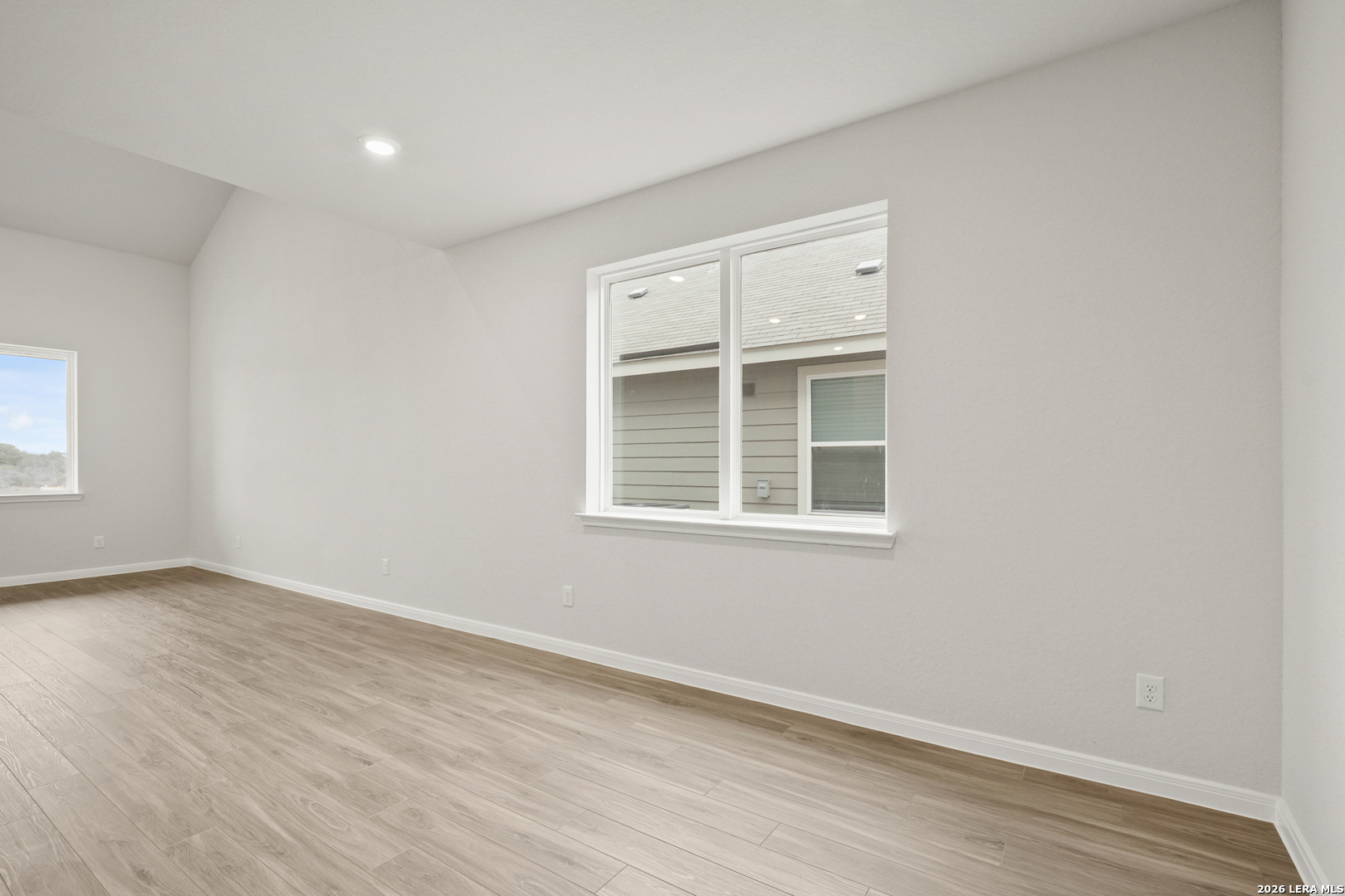 13631 Helton Pass St. Hedwig, TX 78152 - Photo 6 of 33 an empty room with wooden floor and windows