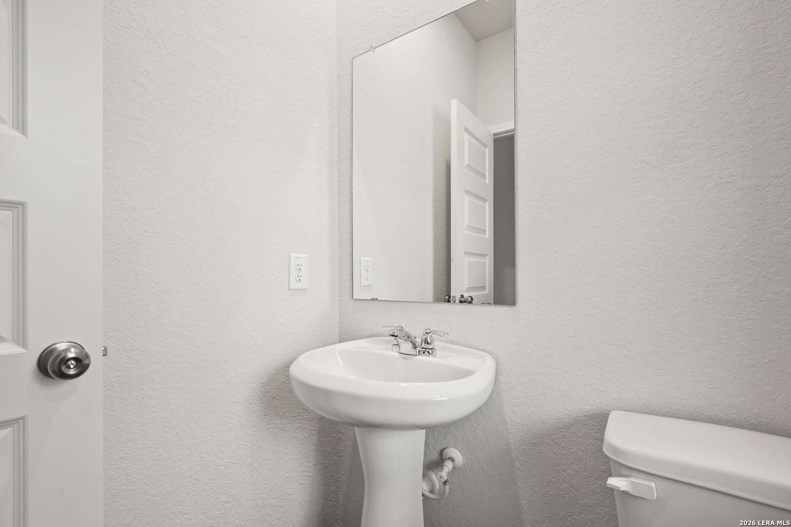 13631 Helton Pass St. Hedwig, TX 78152 - Photo 8 of 33 a bathroom with a sink a toilet and mirror