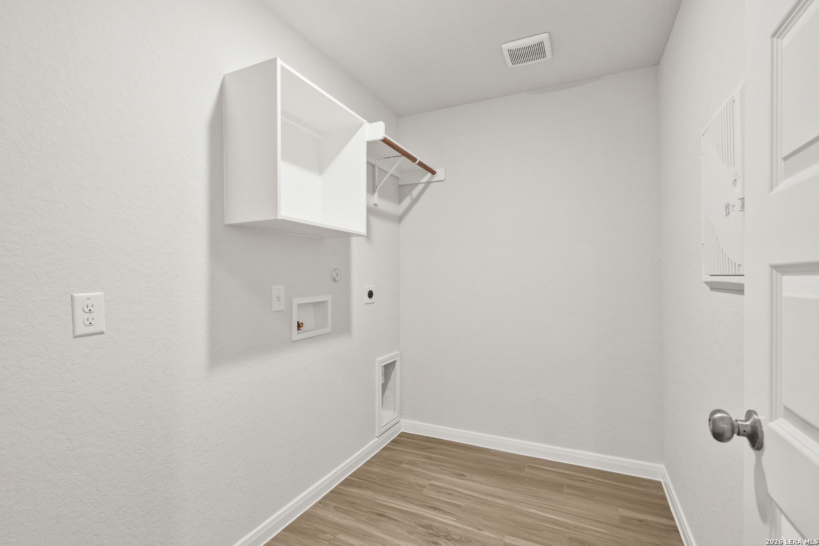 13631 Helton Pass St. Hedwig, TX 78152 - Photo 9 of 33 a view of a room with wooden floor and white walls