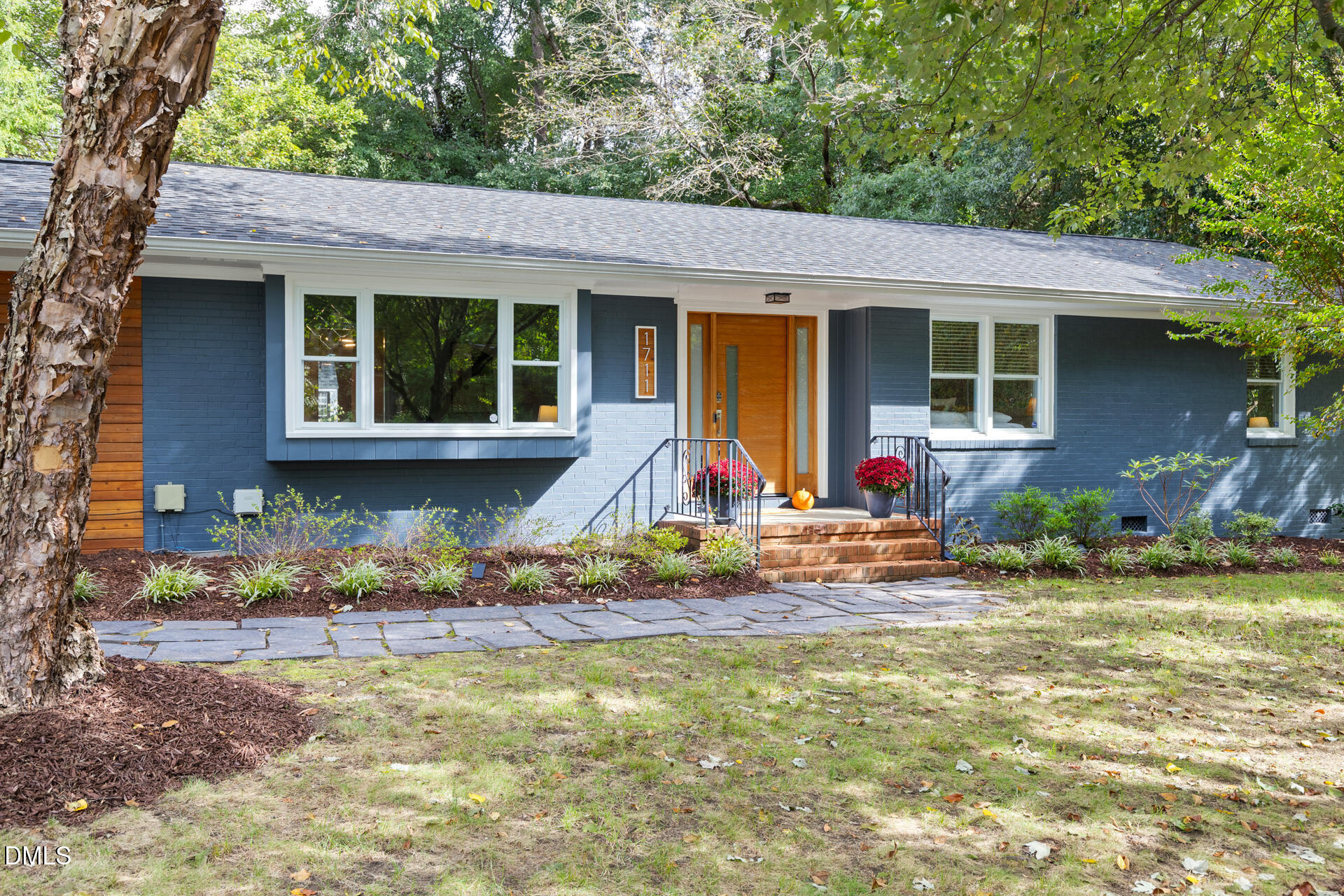 a view of house with yard and sitting area