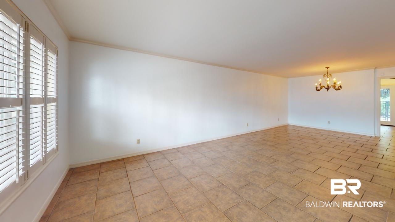 4009 Old Shell Road, Unit C13 Mobile, AL 36608 - Photo 6 of 32 Spare room featuring a chandelier, baseboards, and ornamental molding