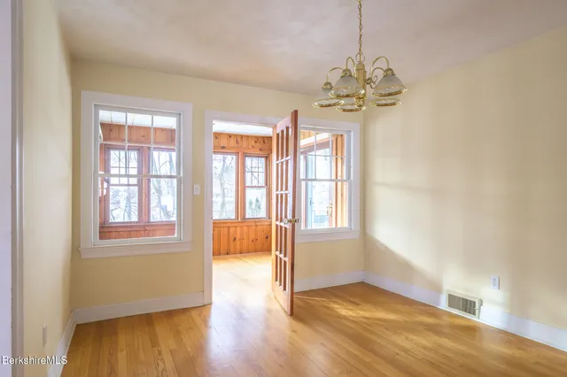a view of a house with a yard covered in snow