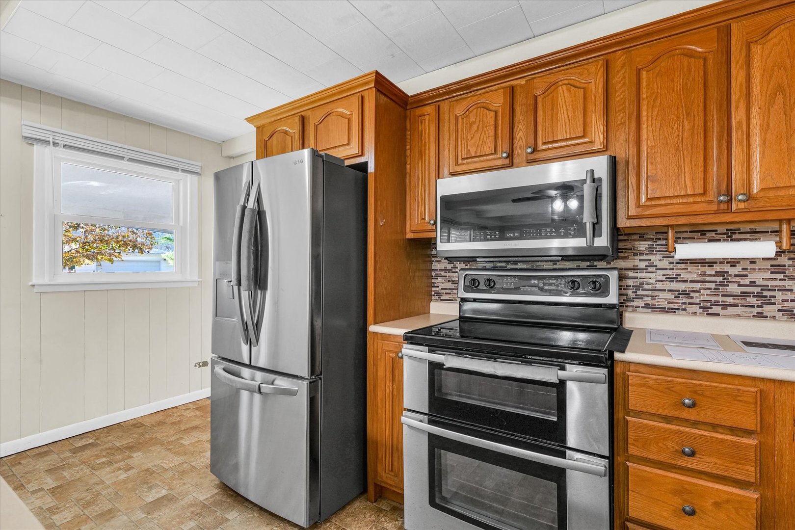 101 Delmar Catlin, IL 61817 - Photo 15 of 32 a kitchen with stainless steel appliances granite countertop a refrigerator and a stove top oven