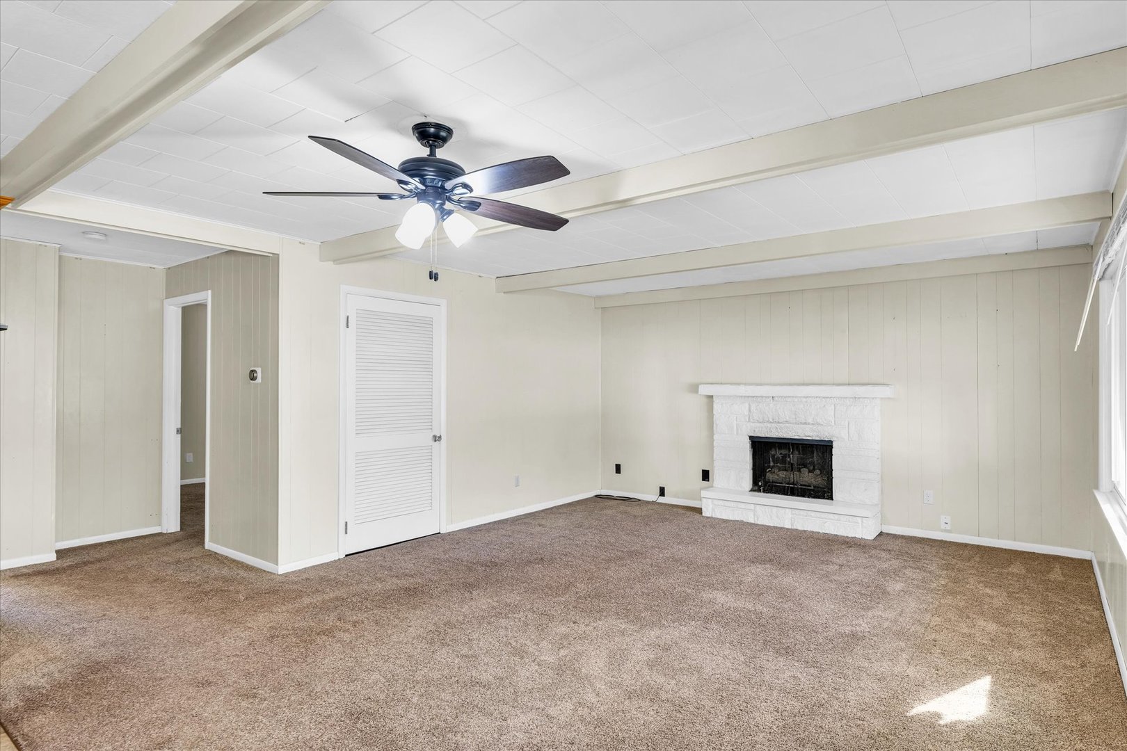 101 Delmar Catlin, IL 61817 - Photo 7 of 32 a view of an empty room with a ceiling fan and a window
