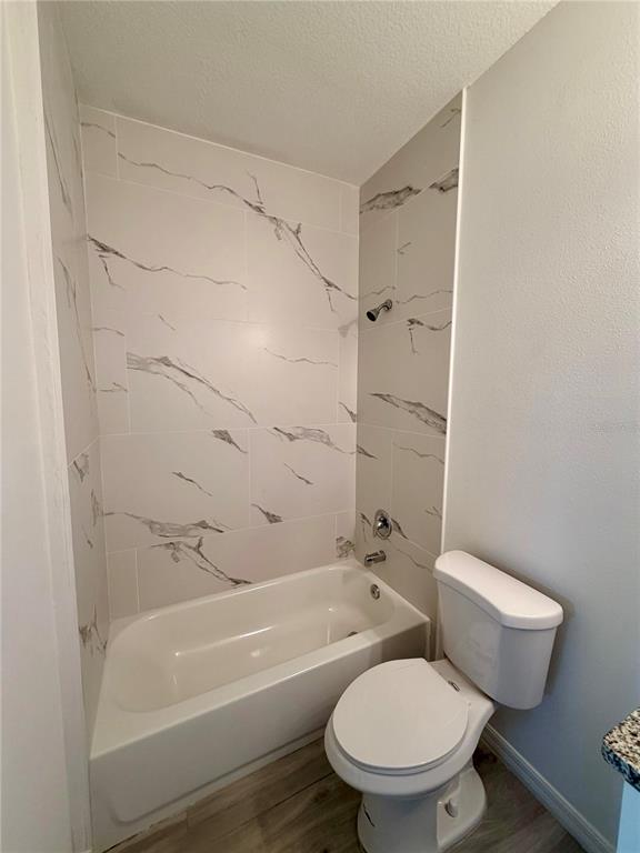14142 Appleton Boulevard Port Charlotte, FL 33981 - Photo 17 of 26 a white toilet and tub next to a bathroom sink
