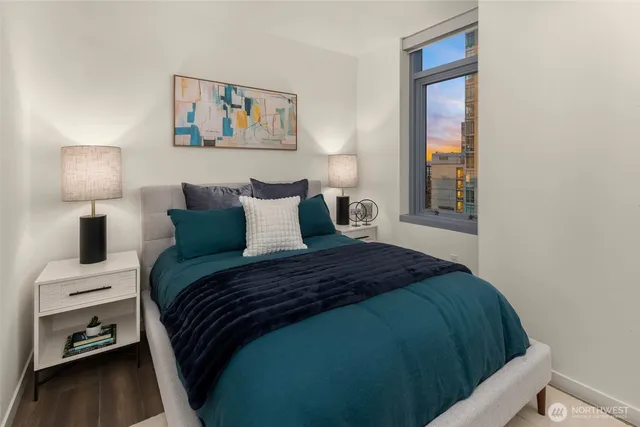 a bedroom with a bed and a night stand