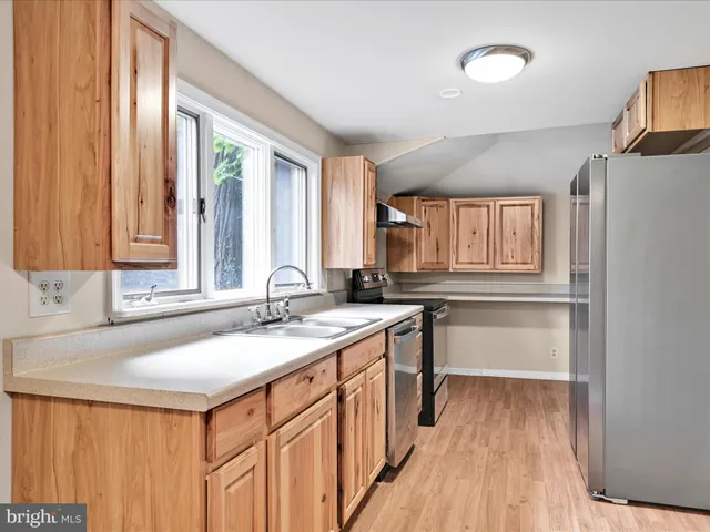 a large bed sitting in a bedroom next to a window
