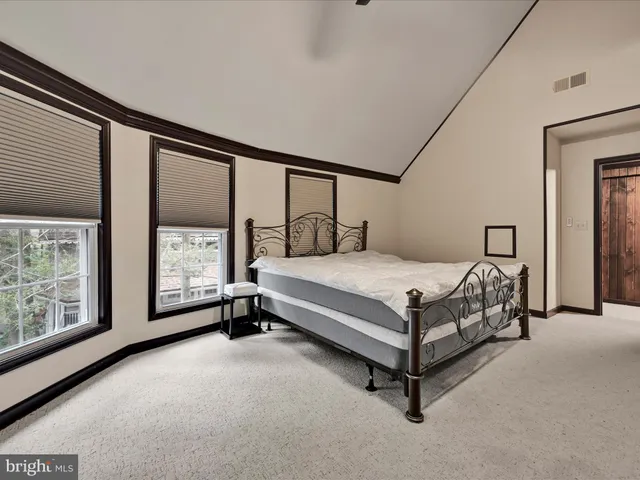 a bathroom with a sink a toilet a mirror and shower