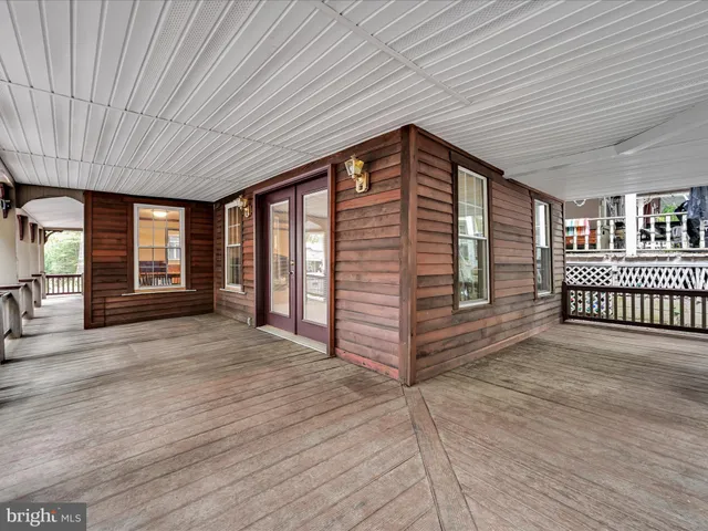 a view of a porch with wooden floor and outdoor space