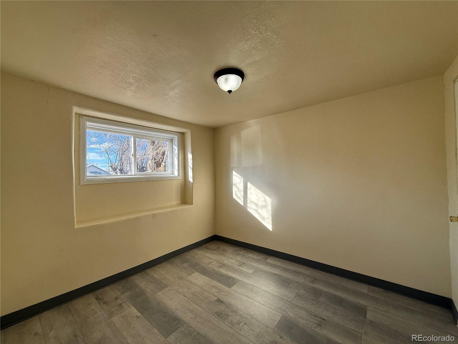 623 9th Street Alamosa, CO 81101 - Photo 5 of 10 an empty room with windows