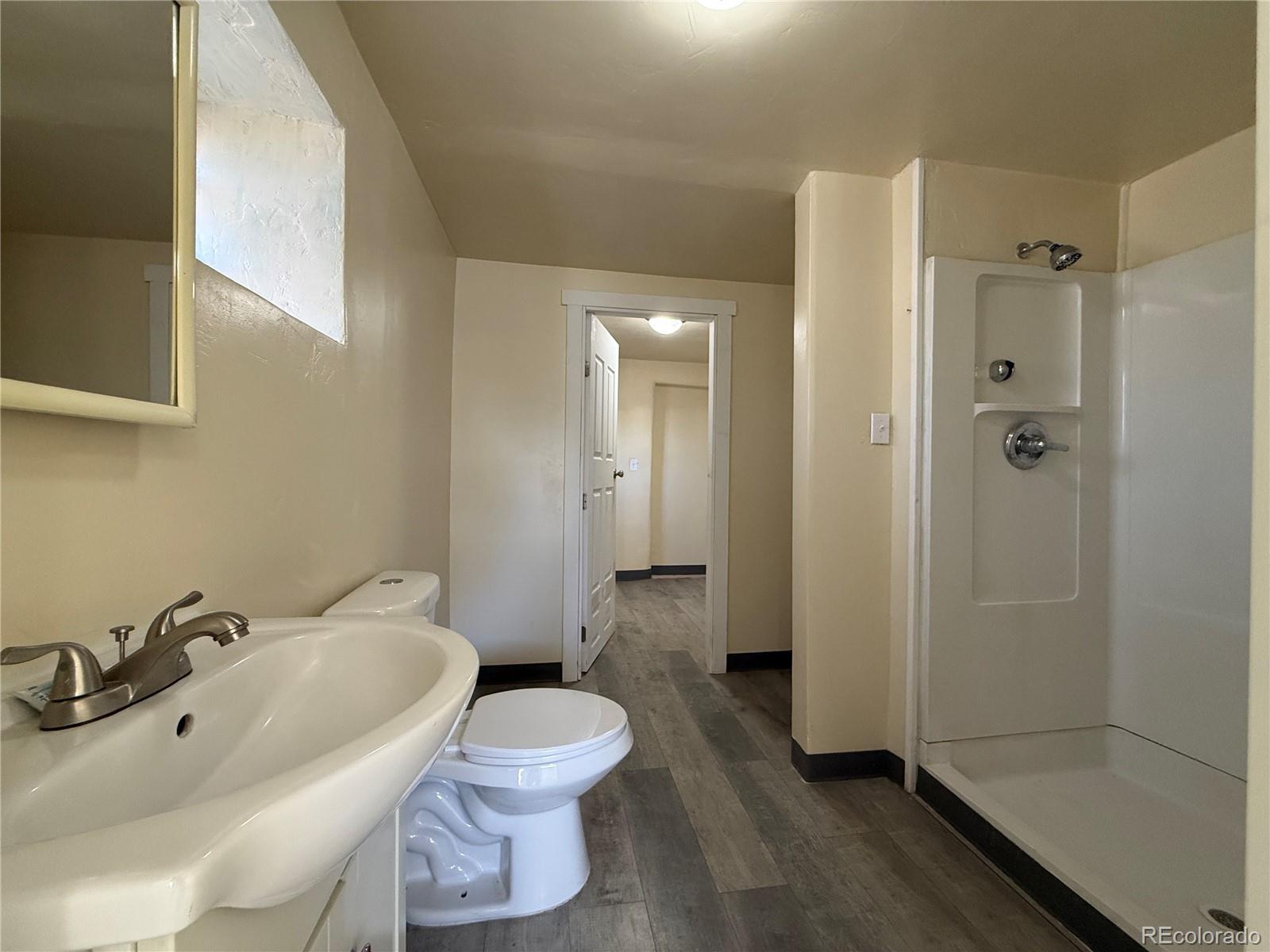 623 9th Street Alamosa, CO 81101 - Photo 10 of 10 a bathroom with a sink toilet and shower