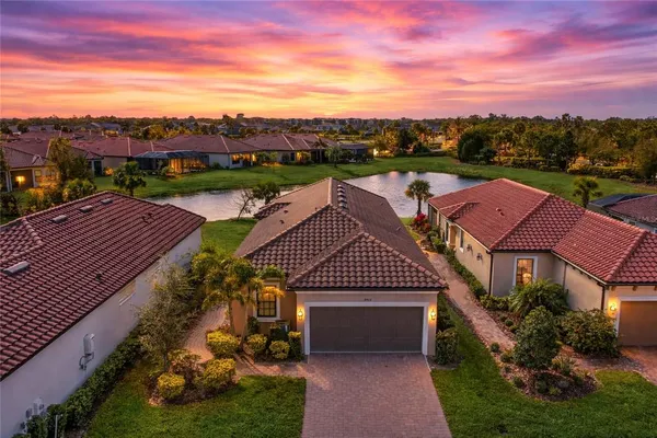 a front view of a house with a garden and plants