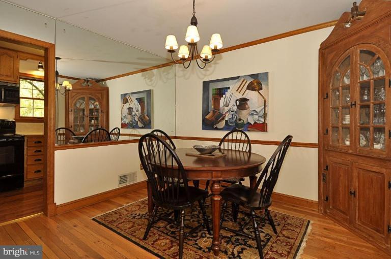 10003 Raynor Road Silver Spring, MD 20901 - Photo 11 of 28 a view of a dining room with furniture and wooden floor