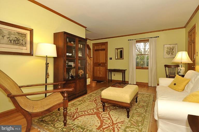 10003 Raynor Road Silver Spring, MD 20901 - Photo 13 of 28 a living room with furniture a lamp and a table