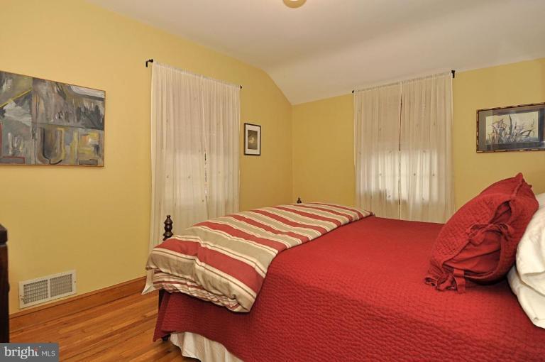 10003 Raynor Road Silver Spring, MD 20901 - Photo 17 of 28 a bedroom with a bed and wooden floor