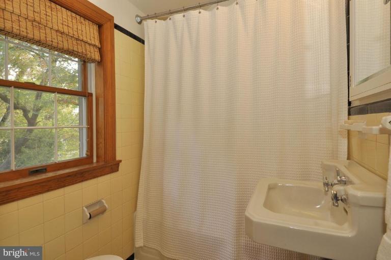 10003 Raynor Road Silver Spring, MD 20901 - Photo 20 of 28 a bathroom with a sink a window and a shower
