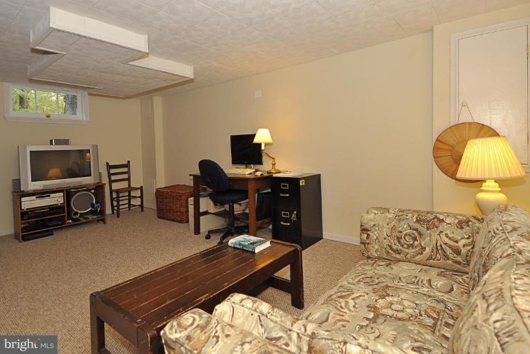 10003 Raynor Road Silver Spring, MD 20901 - Photo 24 of 28 a living room with furniture and a flat screen tv
