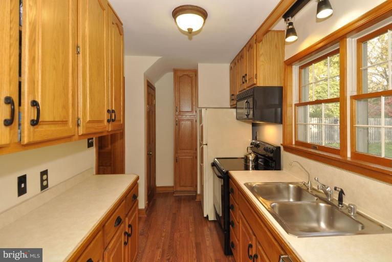 10003 Raynor Road Silver Spring, MD 20901 - Photo 10 of 28 a kitchen with stainless steel appliances a sink a stove and a refrigerator