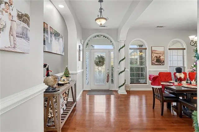 a view of a dining room with furniture and wooden floor
