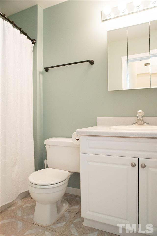 17 Hidden Hills Road Roxboro, NC 27574 - Photo 22 of 30 a bathroom with a sink a toilet and a mirror