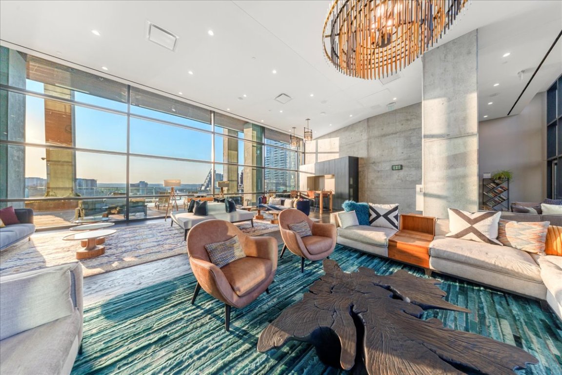 70 Rainey Street, Unit 1503 Austin, TX 78701 - Photo 15 of 30 Lobby with a city view, a towering ceiling, a wall of windows, and recessed lighting