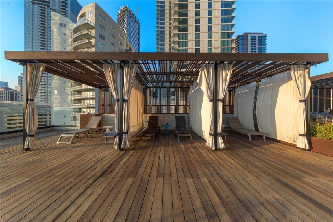 70 Rainey Street, Unit 1503 Austin, TX 78701 - Photo 18 of 30 Wooden deck featuring a skyline view and a pergola