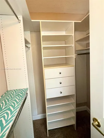 a view of hallway with furniture and shower