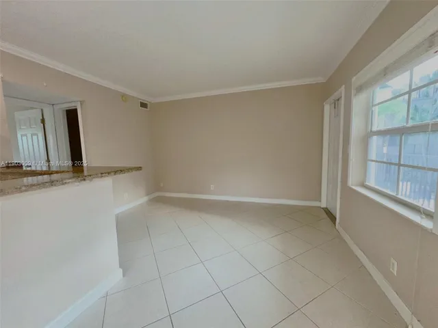 a kitchen with stainless steel appliances kitchen island granite countertop a refrigerator and a sink