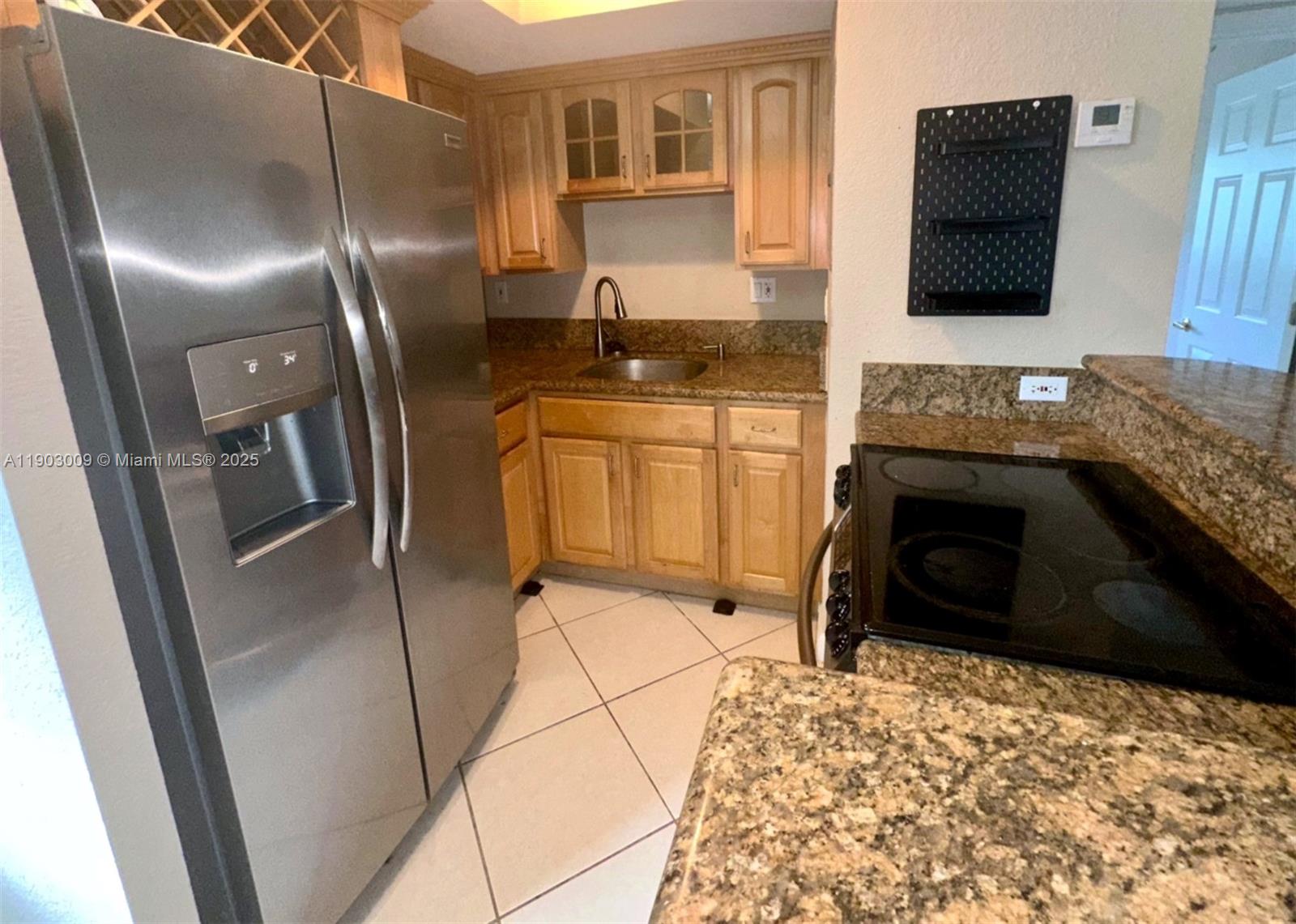 924 Southeast 2nd Street, Unit 9 Fort Lauderdale, FL 33301 - Photo 8 of 19 a kitchen with a refrigerator and a stove top oven