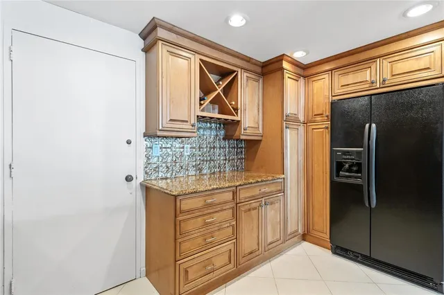 a kitchen with a refrigerator and cabinets