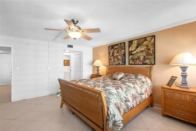 a bedroom with a bed and a lamp on dresser