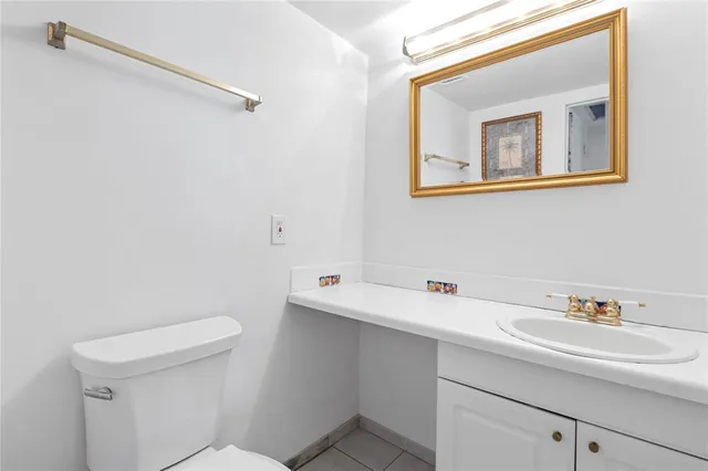 a bathroom with a sink a toilet and mirror