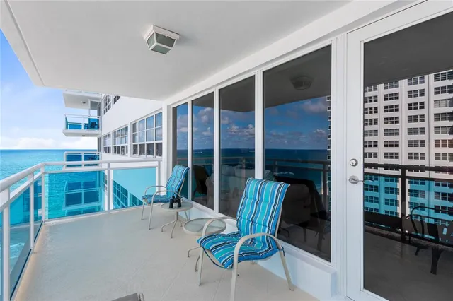 a view of a house with a porch and furniture