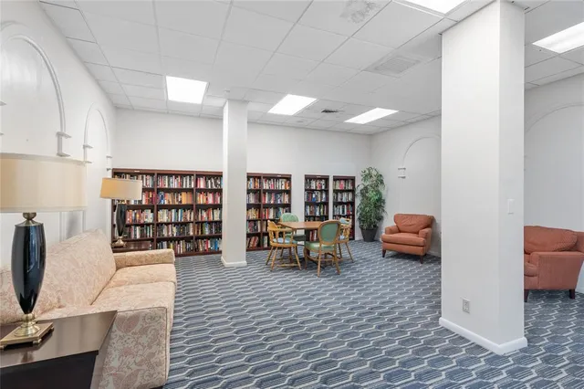 a room with furniture pool table and window