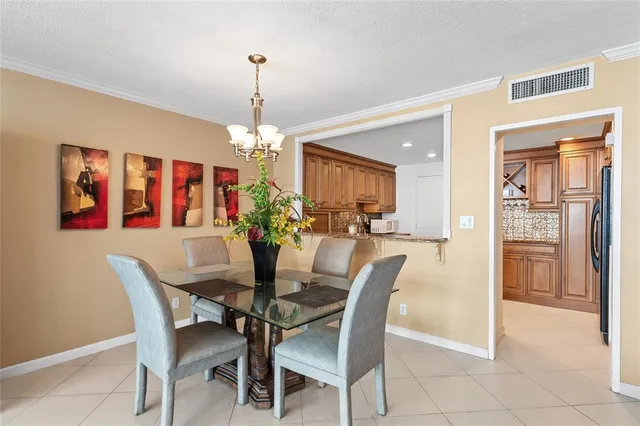 a dining room with furniture a chandelier and window