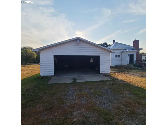 a view of a house with a yard and a garage