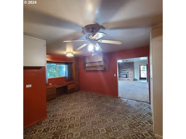 a view of livingroom with a ceiling fan and a rug