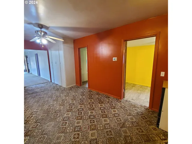 a view of a hallway with closet and wooden floor