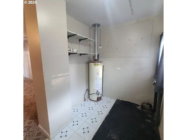 a view of hallway with stairs and a wooden floor