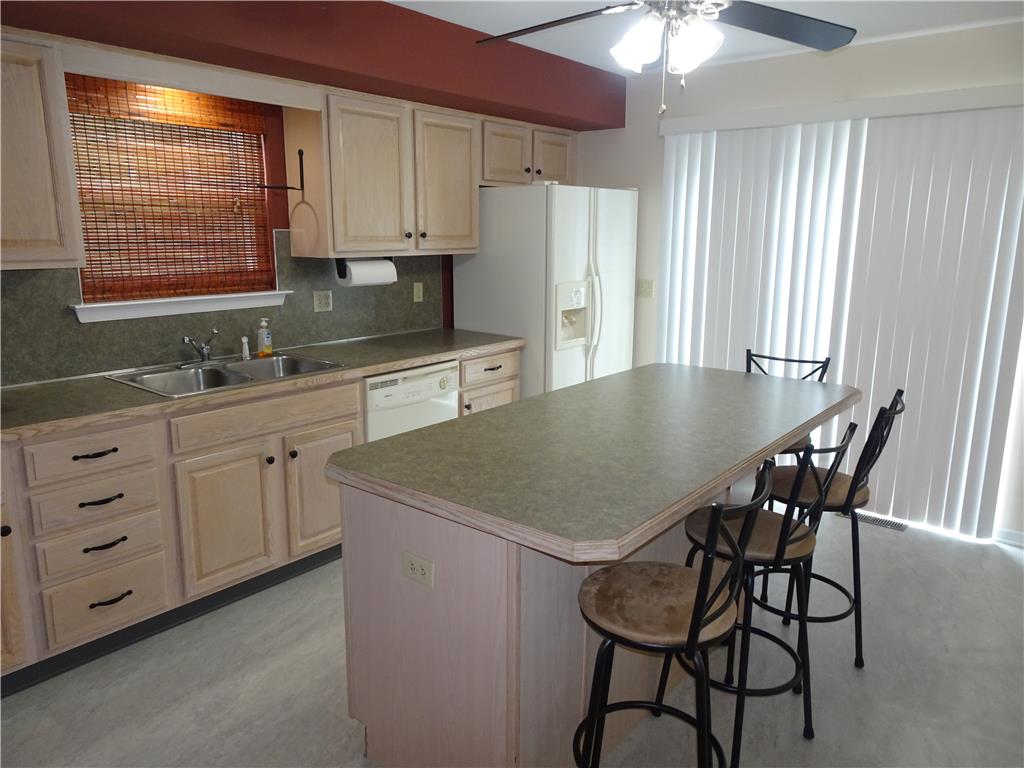 4435 Steuben Road Bethlehem, PA 18020 - Photo 12 of 43 A well-appointed kitchen features a practical island with seating and sliding doors to the exterior.
