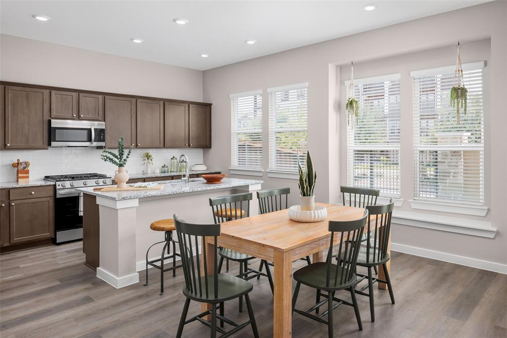 4304 Stonybrook Road Arlington, TX 76005 - Photo 4 of 17 a kitchen with a table chairs stove and cabinets
