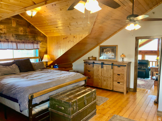 76 Highway 118 Monroe, UT 84754 - Photo 36 of 76 Bedroom with multiple windows, wood ceiling, lofted ceiling, light wood-style floors, and wooden walls