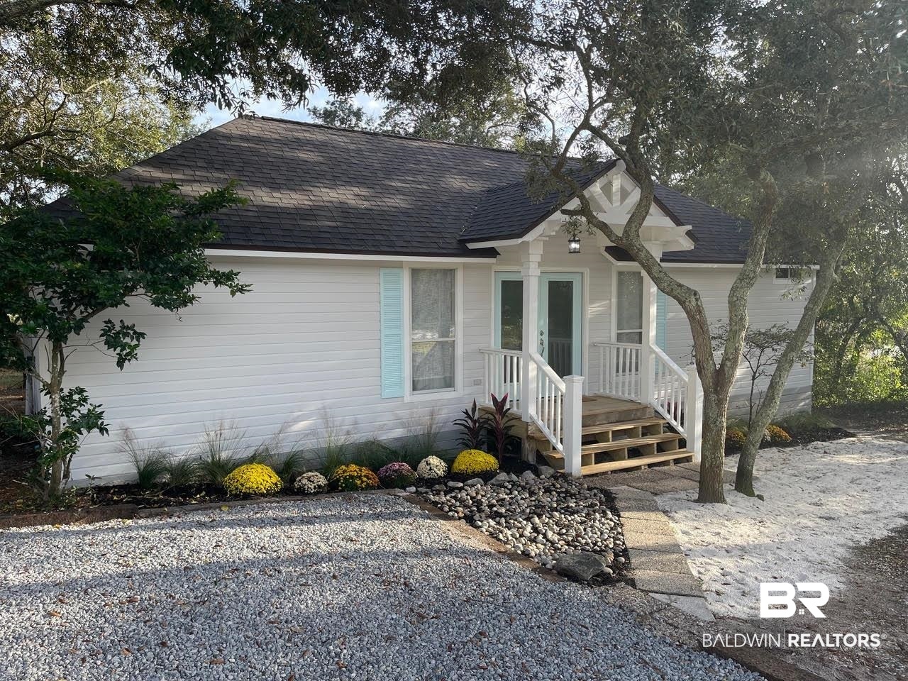 413 West Fort Morgan Road Gulf Shores, AL 36542 - Photo 2 of 29 View of front of property featuring a shingled roof and french doors