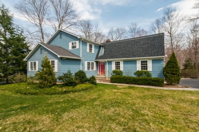 34 Salem Road Wilton, CT 06897 - Photo 1 of 1 a front view of a house with a yard and garage