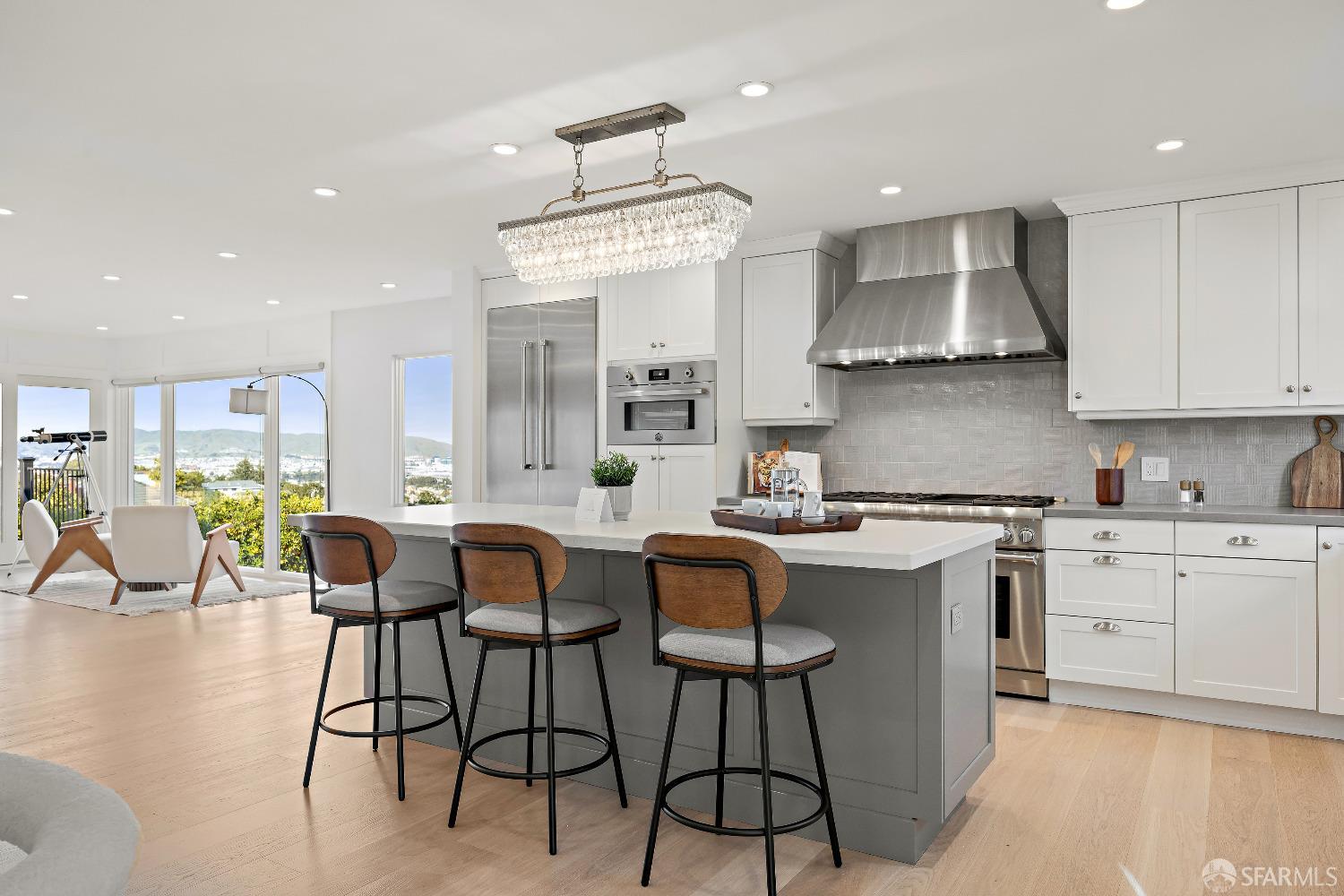 1270 Roble Road Millbrae, CA 94030 - Photo 26 of 61 a kitchen with stainless steel appliances a table chairs sink and cabinets