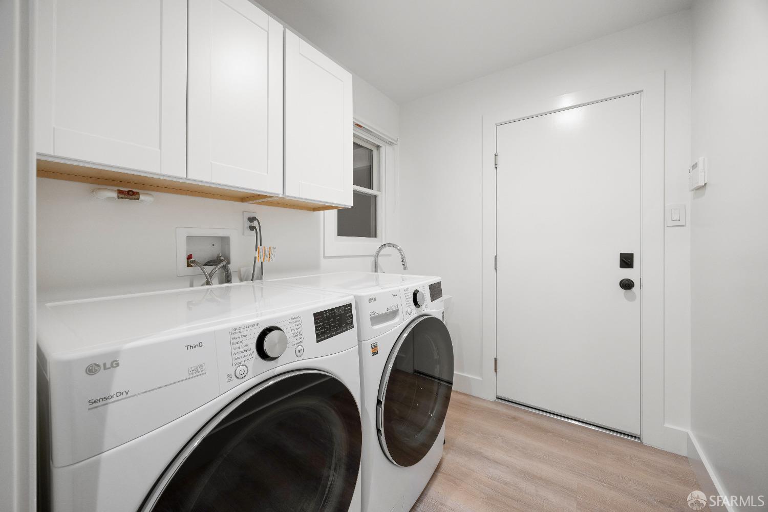 1270 Roble Road Millbrae, CA 94030 - Photo 51 of 61 a view of washer and dryer with kitchen in the background