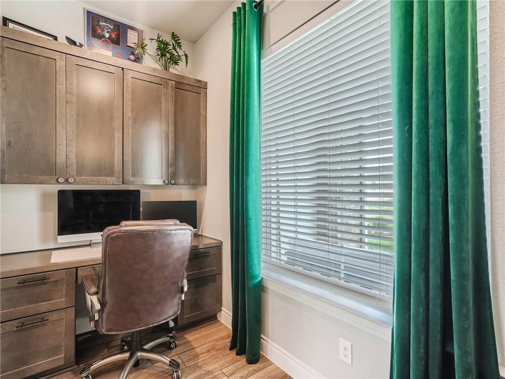 132 Huerta Road Florence, TX 76527 - Photo 19 of 40 Integrated desk and cabinetry define this well-appointed home office space.